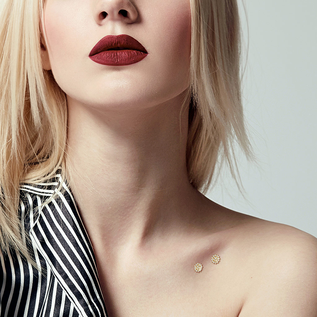 Dermal van 14 karaats goud met steen bezet bloemetje